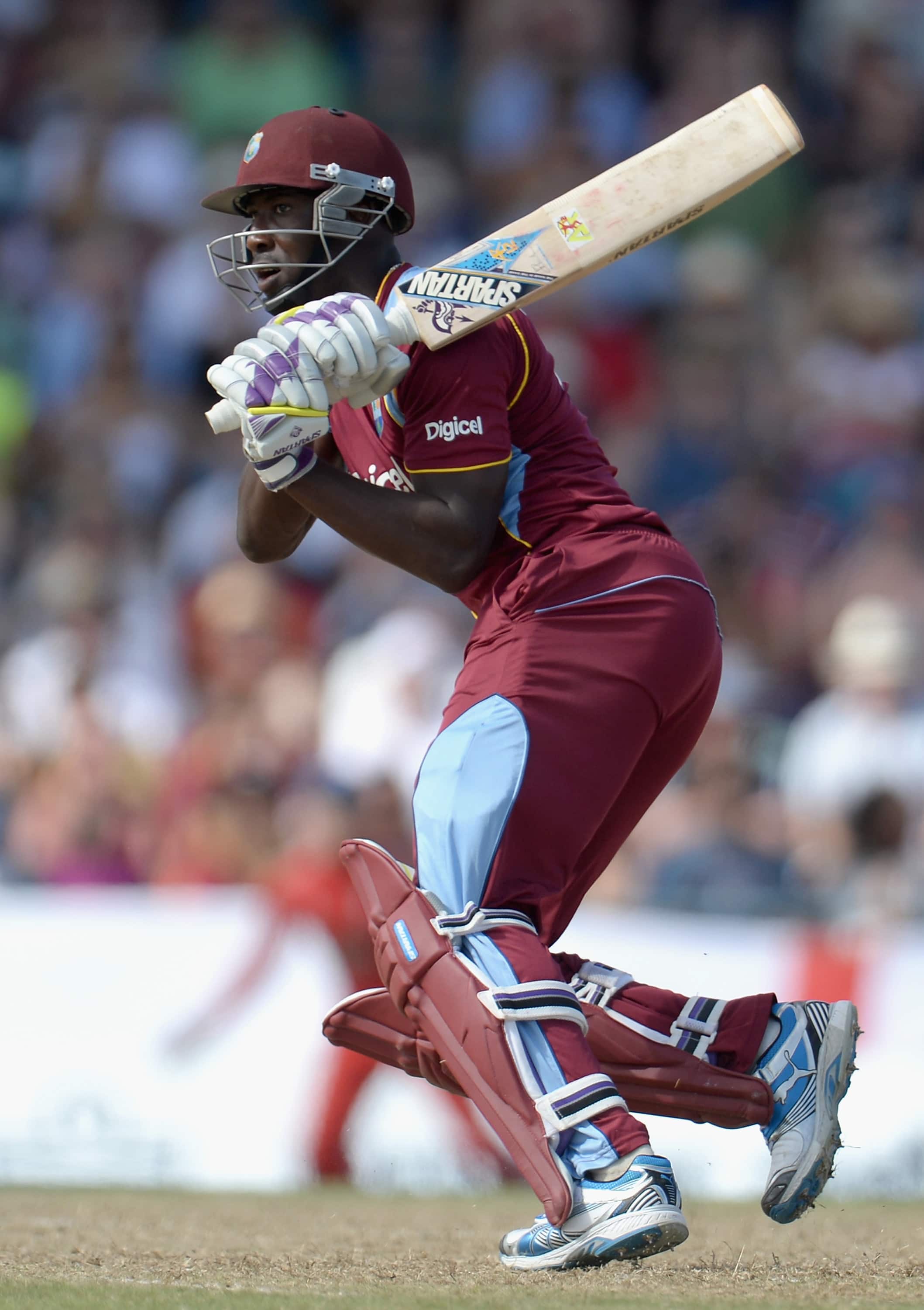 Andre Russell of West Indies plays a str...