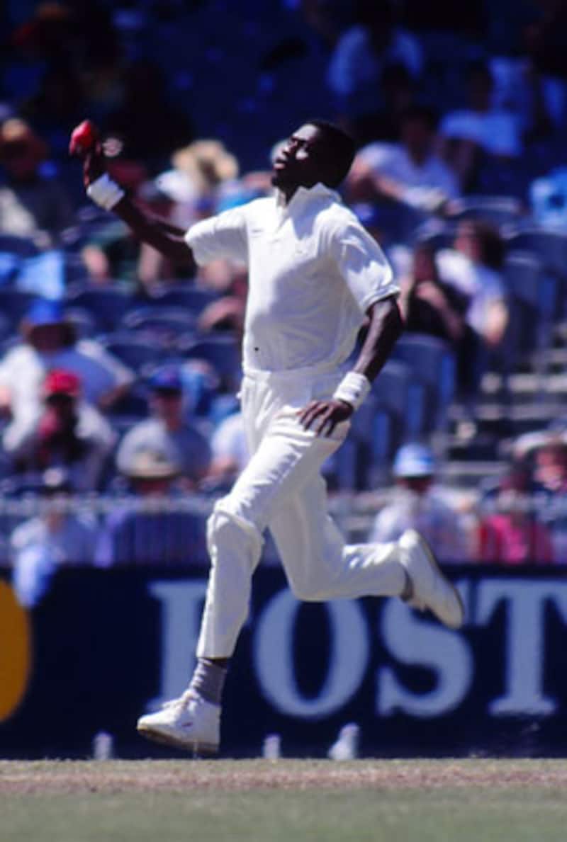 At 6ft 7in, Curtly Ambrose was in the standard-issue mould of hostile West-Indian fast bowlers of the â80s. His loping run up to the wicket with the high release must have been a scary sight for batsmen facing him © Getty Images