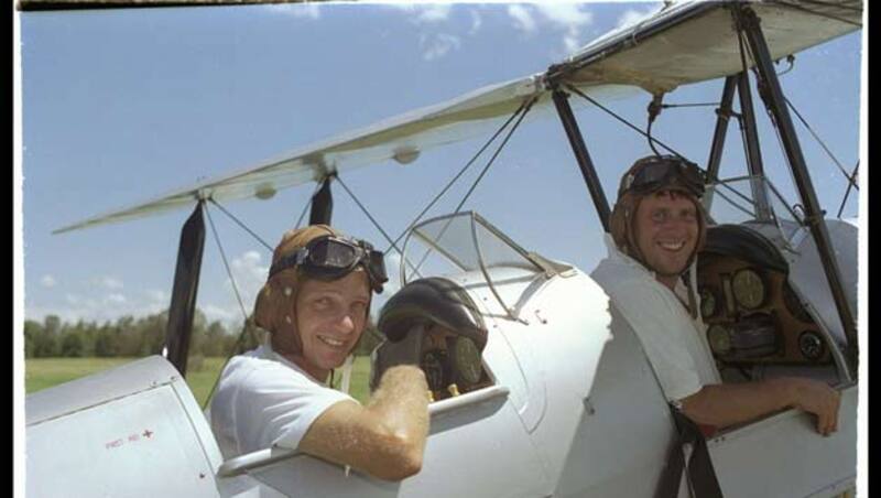 David Gower (left) and John Morris prepare to take the infamous Tiger Moth flight over an Australian cricket ground during the 1991 England Ashes tour. Both were heavily reprimanded for the incident &copy; Getty Images