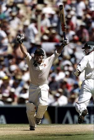 Michael Slater celebrates reaching his century in the second innings of the fifth Ashes Test in the 1998-99 series at the SCG © Getty Images
