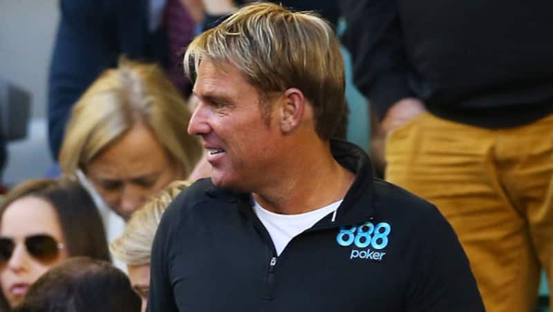 Cricketer-Shane-Warne-watches-Roger-Federer-of-Switzerland-in-his-quarterfinal-match-against