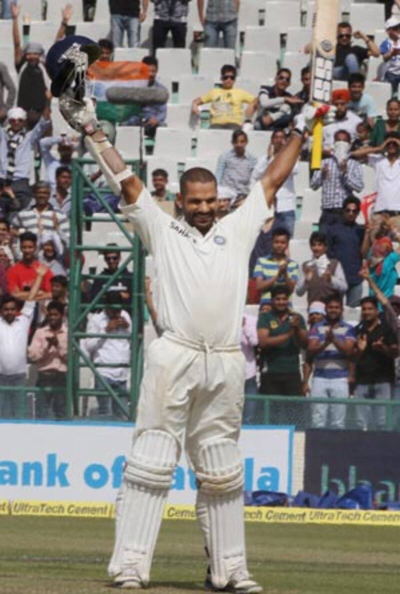 Shikhar Dhawan raises his arms after completing his ton on Test debut. This became his signature style after completing his tons which he kept scoring throughout 2013 © PTI