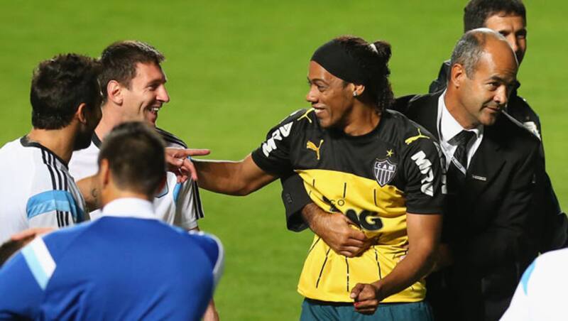 Security officials escort the Ronaldinho look-alike  &Acirc;&copy; Getty Images