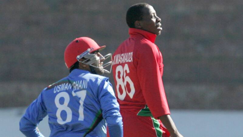 Afghanistan batsman Usman Ghani (L) and Zimbabwe bowler Shingirai Masakadza watch the ball glide towards the boundary in the second One-Day International between Zimbabwe and Afghanistan at Bulawayo &copy; AFP
