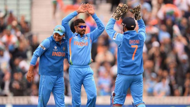 Ravrinda-Jadeja-of-India-celebrates-with-Mahendra-Singh-Dhoni-and-Suresh-Raina-(L)-after-dismissing-Johnson-Charles-of-West-Indies-during-the-ICC