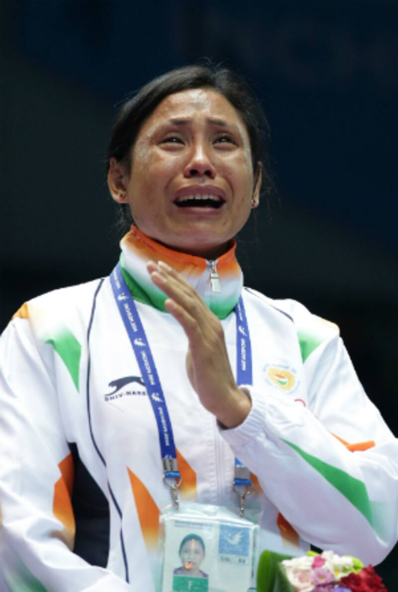 Sarita Devi in tears at the podium during the medal presentation ceremony at the Incheon Asian Games 2014 &copy; Getty Images