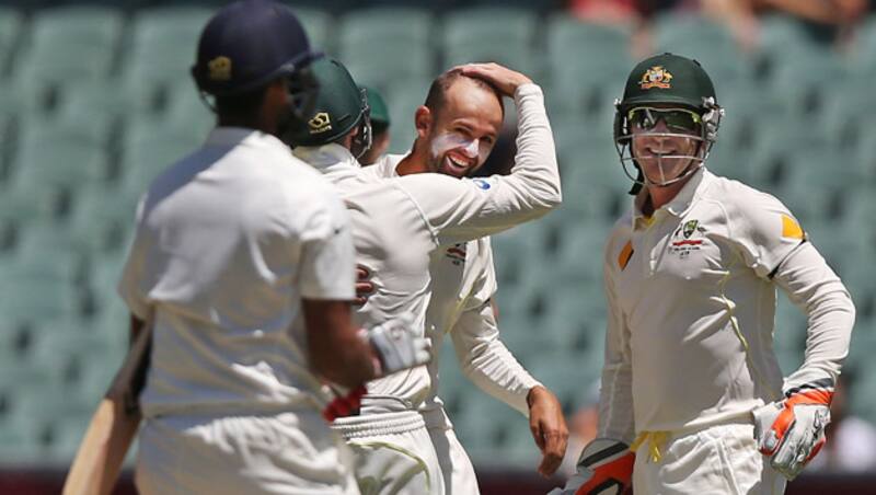 Australian fielders gather around Nathan Lyon as he celebrates a wicket &Acirc;&copy; Getty Images