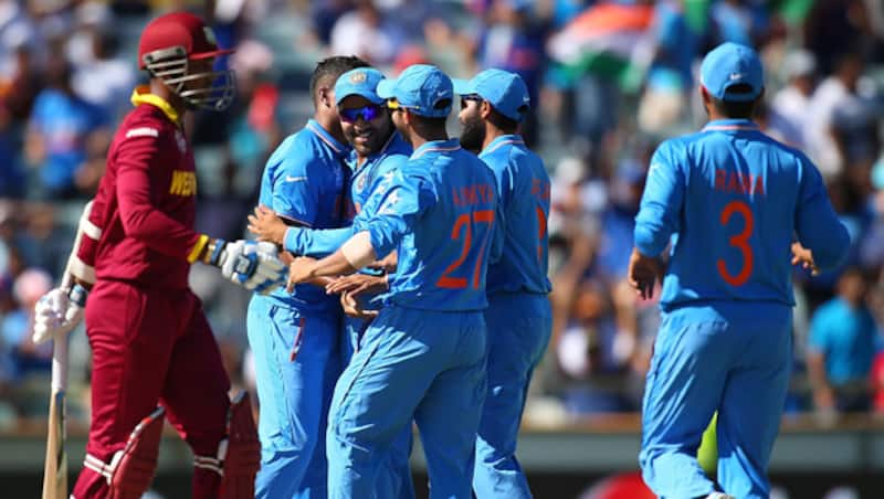 The Indian players celebrate the wicket of West Indies wicket-keeper batsman Denesh Ramdin (left) © Getty Images