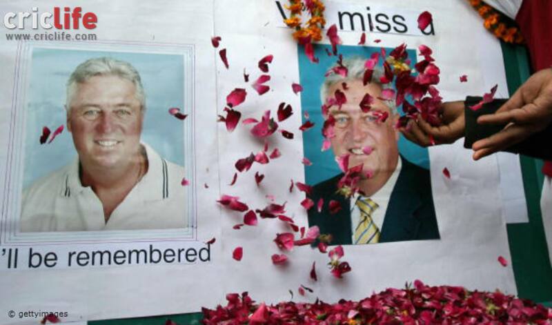 Members of The Pakistani Cricket Welfare Association scatter rose petals towards pictures of late Pakistani coach Bob Woolmer during a condolance ceremony in Lahore