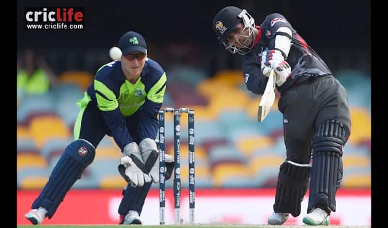 Gary Wilson looks on as UAE&acirc;s Shaiman Anwar launches one over extra-cover