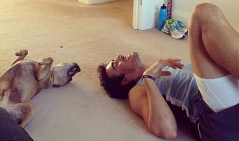 Mithcell Starc and his dog in a playful mood.