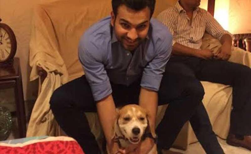 Rohit Sharma, an animal lover and PETA supporter, expressing his joy being with a dog.