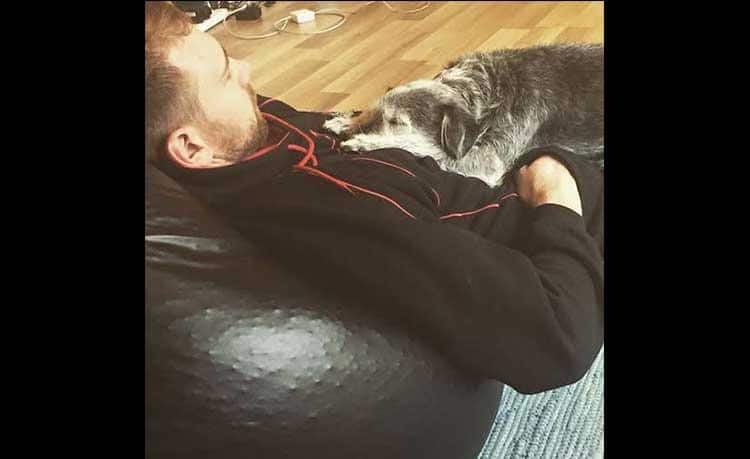 iden Blizzard takes a snooze as does his dog on his lap.