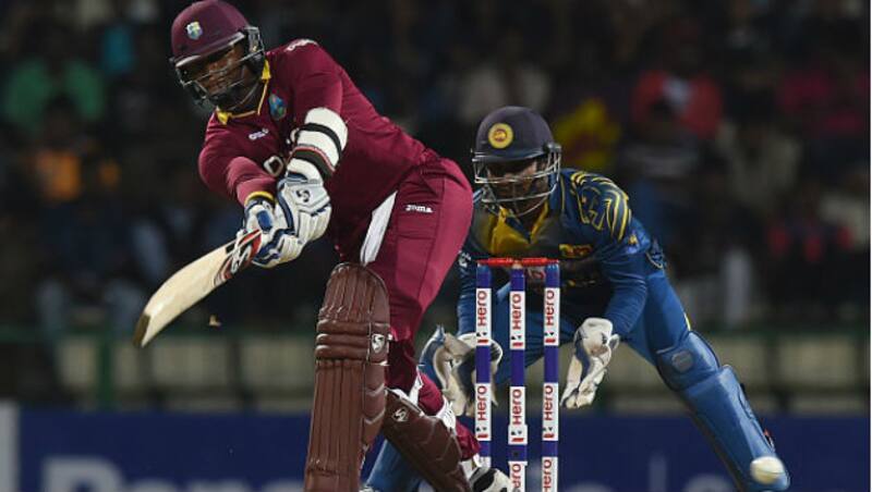 Marlon Samuels plays a shot as wicketkeeper Kusal Perera (right) looks on during the third and final One Day International (ODI) match between Sri Lanka and the West Indies at the Pallekele International Cricket Stadium &copy; Getty Images 