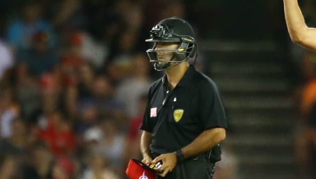 Umpire Gerard Abood pictured in a batting helmet during the BBL clash © Getty Images