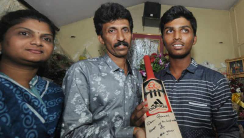 BCCI sent out a tweet of Pranav Dhanawade and his parents posing with the bat gifted by Sachin for his record innings &copy; BCCI Twitter handle