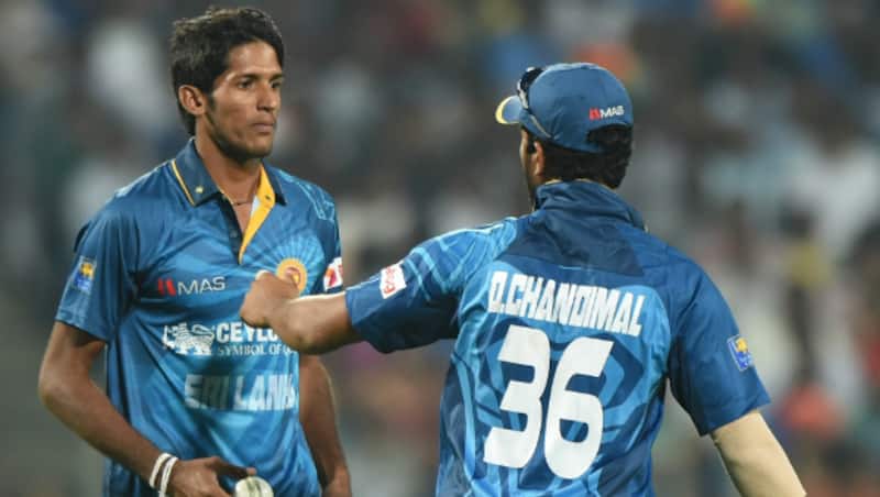 Kasun Rajitha (left) struck twice in the very opening over of the game, putting India on the back foot © AFP