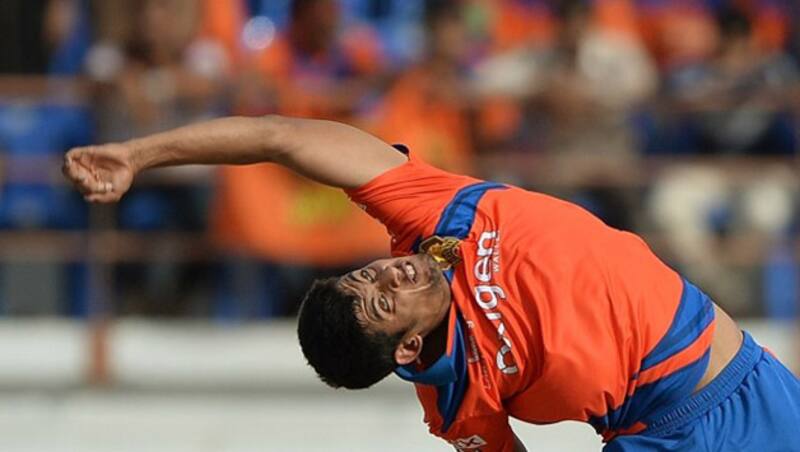 Shivil Kaushik's (Above) bowling action has often been likened to Paul Adams' © AFP