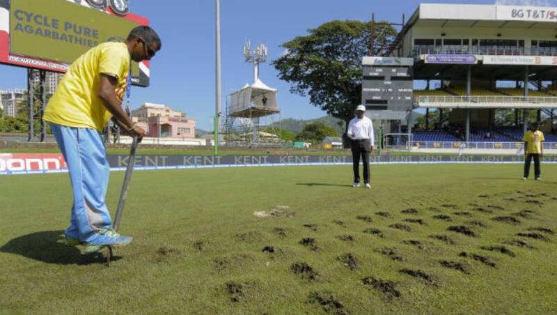 Groundsmen dug up parts f the outfield for the moisture to be absorbed, but that delayed things even further &copy; AFP