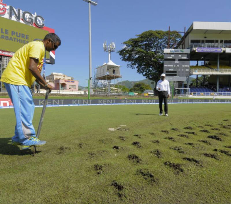 Clear skies but no cricket... Ground staff dig up the field to assist with drying under the supervision of umpire Gregory Brathwaite (C) during day 3 of the 4th and final Test between West Indies and India &copy; AFP