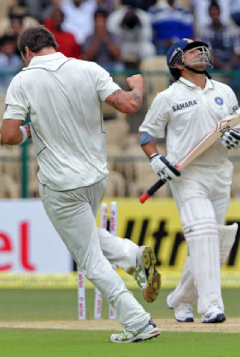 A disgruntle  Sachin Tendulkar goes past Doug Bracewell as he celebrates his wicket &Acirc;&copy; Getty Images