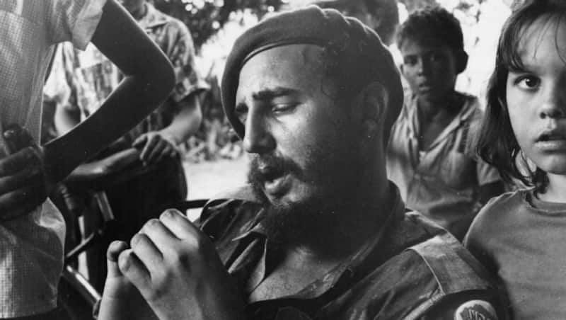 Fidel Castro relaxing at a sugar plantation near Havana, surrounded by children &Acirc;&copy; Getty Images