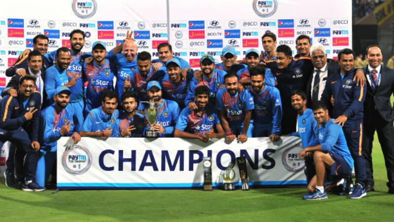 Indian team’s media manager (second from left) seen posing with the side after their recent T20I series win against England © AFP