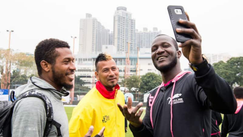 Darren Sammy (right) with Chris Jordan (left) and Rayad Emrit before the start of match &copy; Hong Kong Cricket (Twitter)