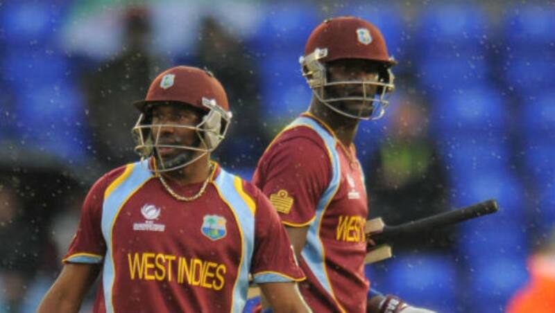 Dwayne Bravo (left) and Darren Sammy look on helplessly as rain resumes; the match would finish in a tie &Acirc;&copy; Getty Images