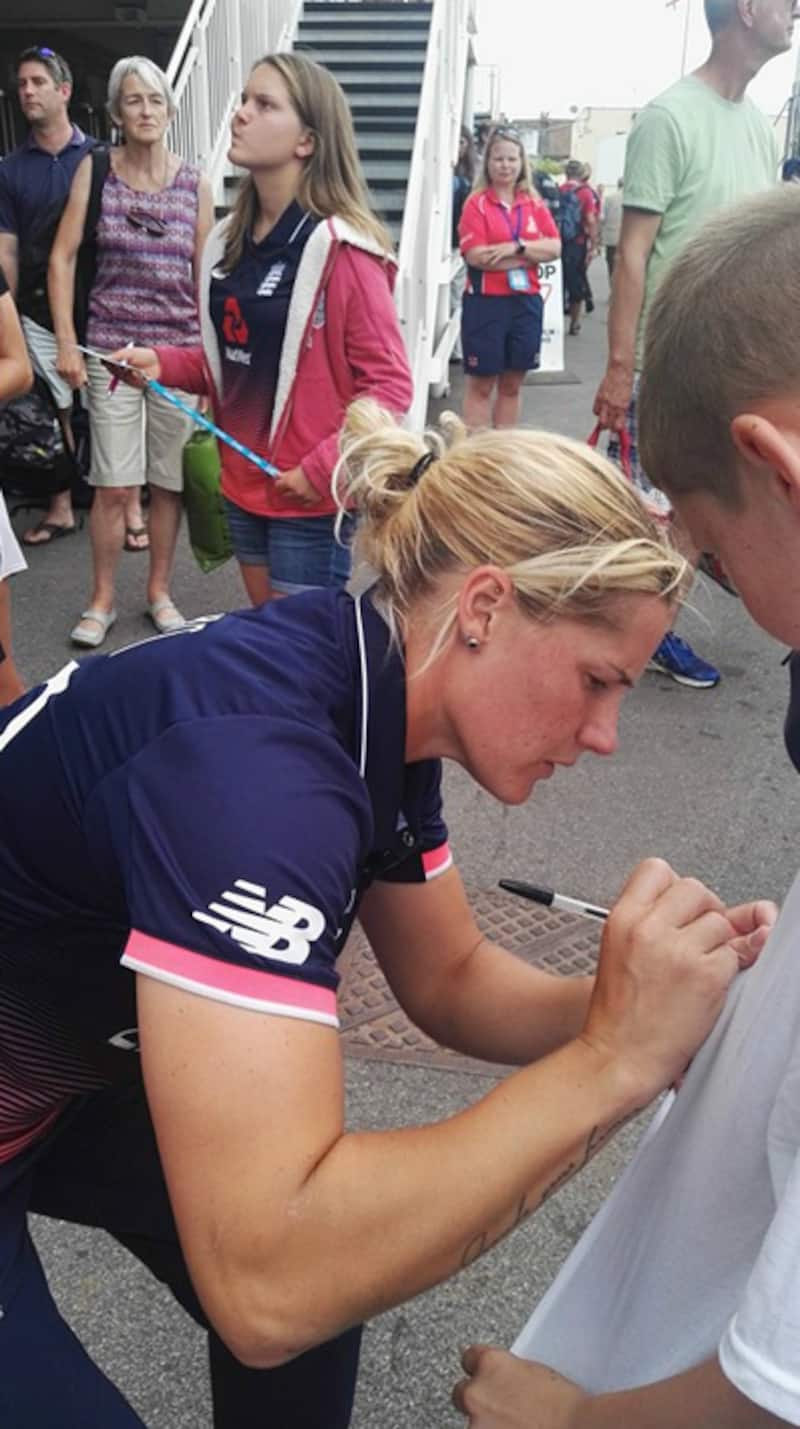 Katherine Brunt signs the tee-shirt of a young fan after the game. One can see what generates the pace. Photo courtesy: Arunabha Sengupta