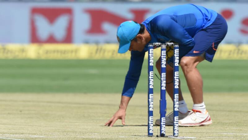 MS Dhoni examines the Pune pitch &copy; AFP