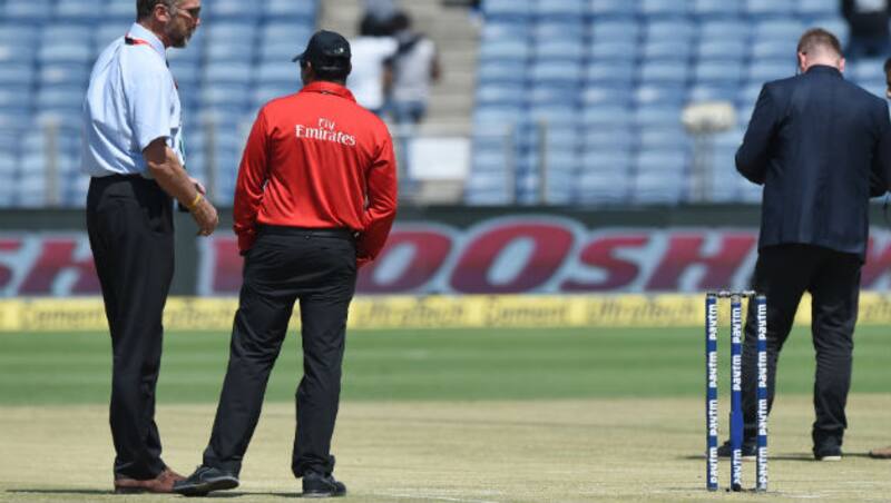 ICC match refree Chris Broad (L) inspecting the pitch at Pune &Acirc;&copy; AFP