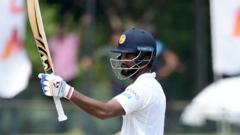 Dimuth Karunaratne raises bat after fifty &copy; AFP