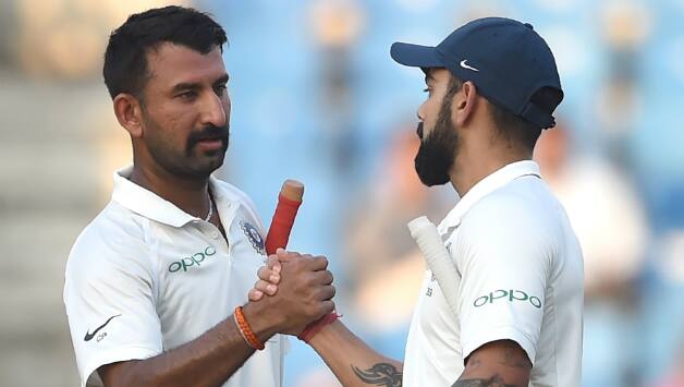 Kohli and Pujara put up a 183 runs partnership © AFP