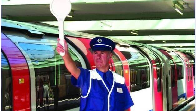 An employee of the London Underground raises the baton. Courtesy: Arunabha Sengupta.