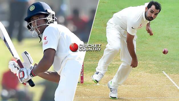 Wriddhiman Saha (L) and Mohammed Shami © AFP