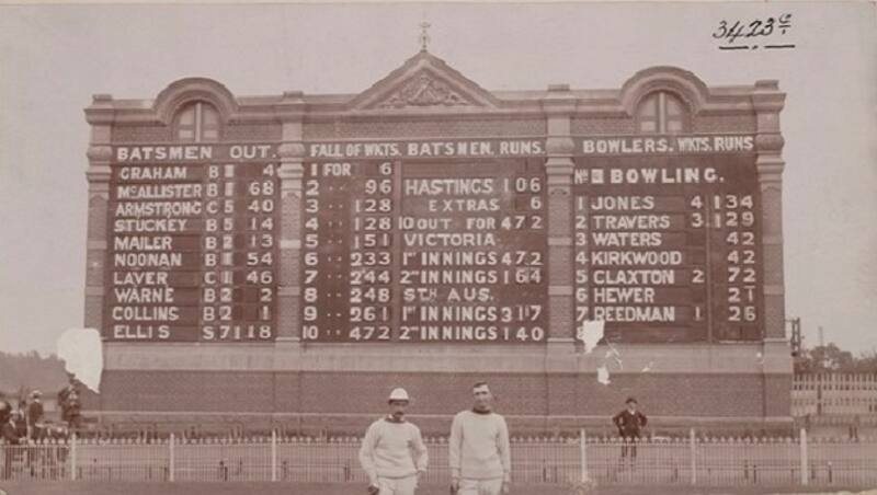 Thomas Hastings (left) and Matthew Ellis (right) in front of the Melbourne Cricket Ground scoreboard that displays their scores. Photographer: John Beaumont (the picture is now out of copyright)