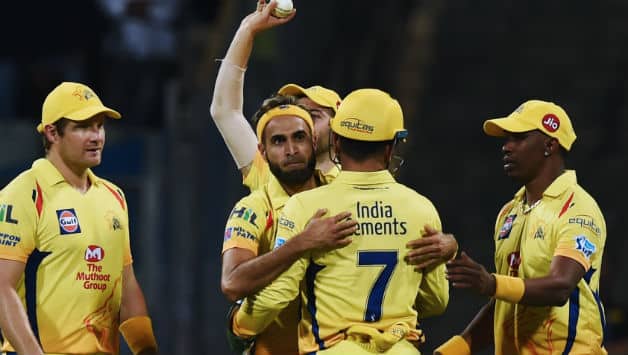 Imran Tahir in the middle being hugged by MS Dhoni © AFP