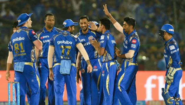 Krunal Pandya celebrates with MI teammates after fall of Rahul Tripathi's wicket © AFP