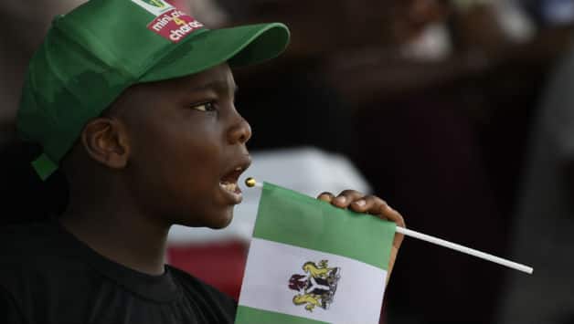 Boy holding Nigeria flag © AFP