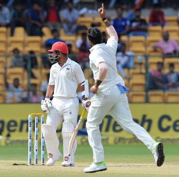 Umesh Yadav traps Mohammad Nabi leg-before; his three-wicket burst in the second innings pushed the Afghans further back © AFP