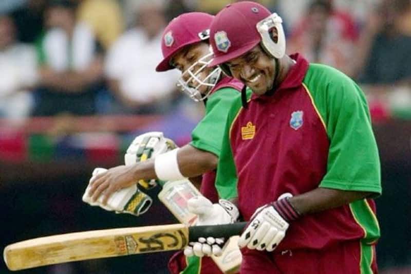 Marlon Samuels celebrates his hundred with skipper Carl Hooper. (AFP image)