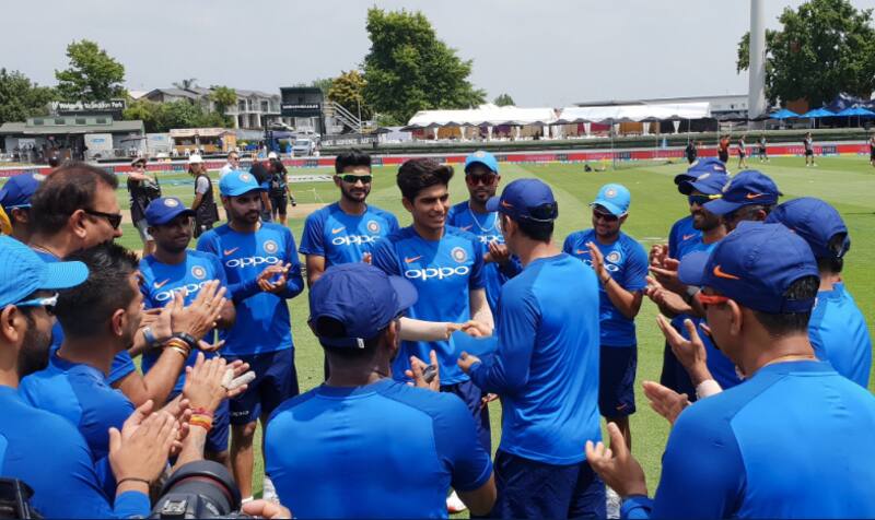 Shubman Gill, 19, receives his first ODI cap from MS Dhoni at Seddon Park.