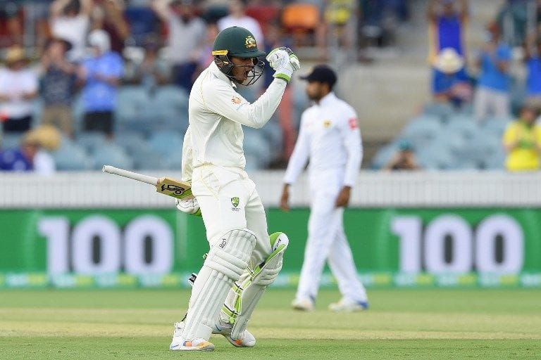 Usman Khawaja celebrates his hundred at Manuka Oval.