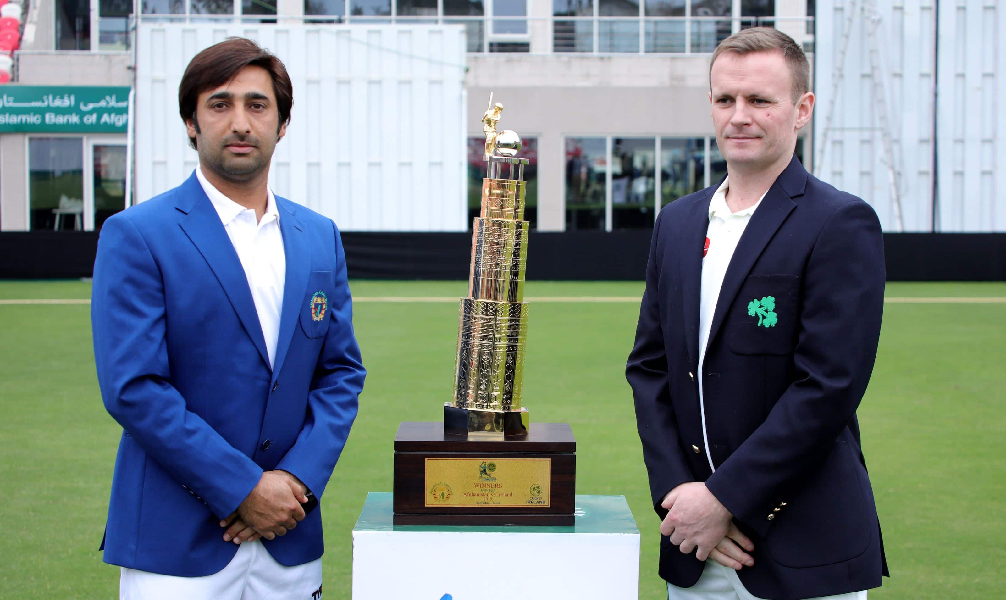 Asghar Afghan and William Porterfield pose with the series trophy.