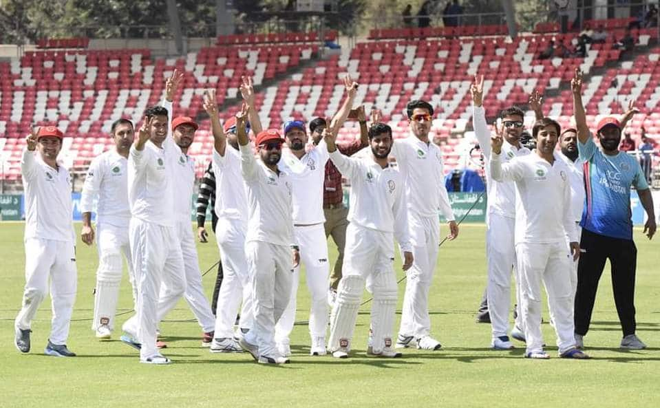 The Afghanistan cricket team celebrates beating Ireland in Dehradun for its maiden Test win.