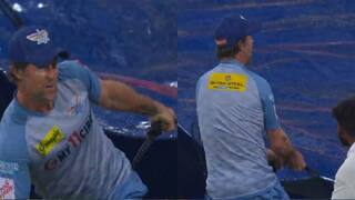 Jonty Rhodes helps the ground staff to cover the pitch as it started raining in LSG vs CSK match